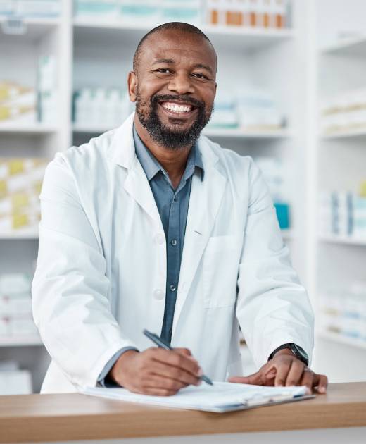 African male doctor giving toy to little patient and talking to him during medical exam at hospital